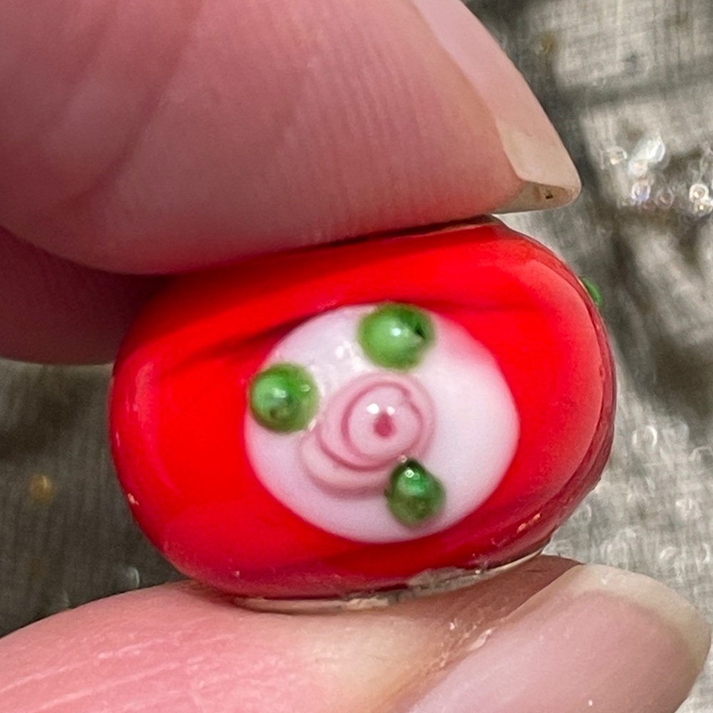 Red murano-style glass bead with pink roses